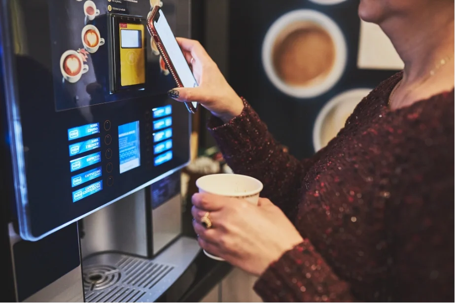 A Women filling the coffee in the coffee mechine