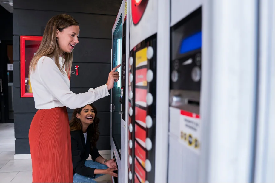 A Women using the vending mechines at on office space